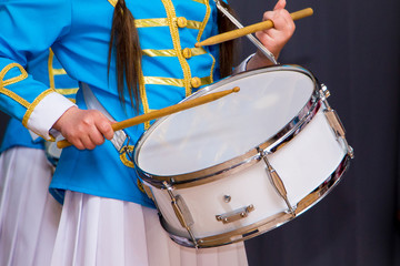 Girl in  stylish  suit is drumming during solemn event_