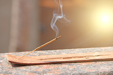 Incense stick and smoke from incense burning. Beautiful smoke. Blurred background and design with...