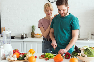 vegan boyfriend cutting vegetables at kitchen
