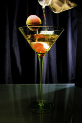 Drink with two cherries in a green cup