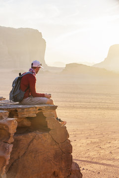 Tourist on rock. Wadi Ram desert. Jordan landscape