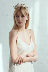 Naklejka premium pensive woman in dress with wreath made of fresh mushrooms on head, vegan lifestyle concept