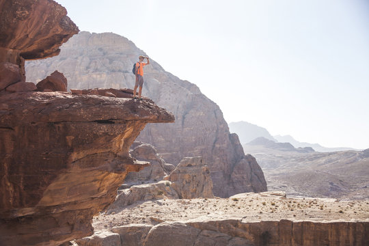 Tourist on rock in Petra. Jordan landscape