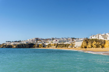 Sandy beach and cliffs in white city of Albufeira, Algarve, Portugal
