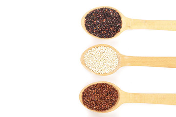 Black red white quinoa and chia seeds in wooden spoon isolated on white background with copy space for your text