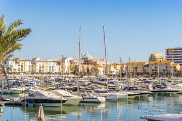 Fototapeta na wymiar Marina full of luxurious yachts in touristic Vilamoura, Algarve, Portugal