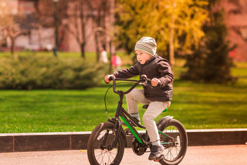 Happy little boy riding a bike