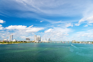 Seascape with bridge and buildings of miami usa on horizon. Skyscrapers of downtown district on...