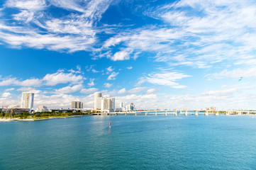 Fototapeta na wymiar Skyscrapers of downtown district of miami usa on cloudy sky. Seascape with bridge and buildings on sea horizon. Architecture and structure design. Summer vacation and travelling