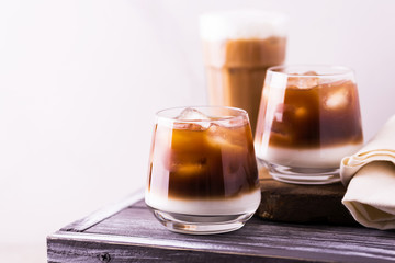 Iced coffee in glasses with milk. Black background
