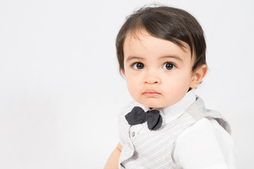 Happy baby Little boy in a white shirt and bow tie portrait