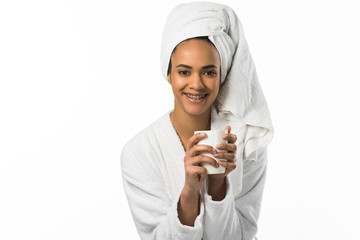 smiling african american woman with dental braces holding cup of coffee,  isolated on white