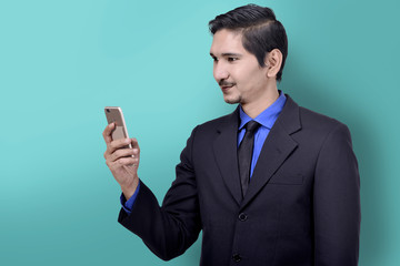 Confident asian businessman holding mobile phone