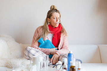 Sick woman measuring temperature with thermometer in her mouth