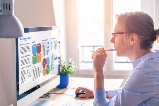 Businesswoman working on Business Plan, computer screen, startup found raising