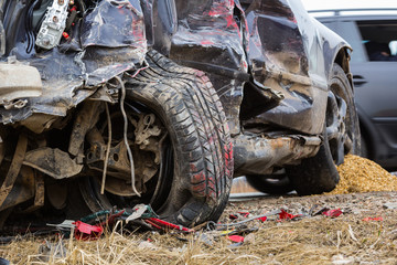 Car accident on a road in April, car after a collision with a heavy truck