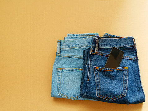 Picture of two jeans with mobile in pocket