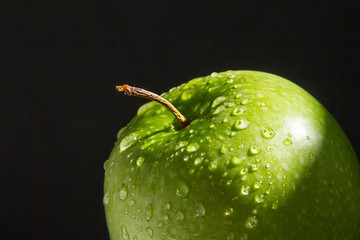 top of green wet fresh Apple on black background