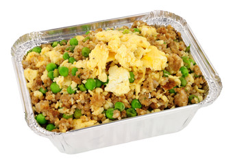 Chinese egg fried rice in a foil take away container isolated on a white background