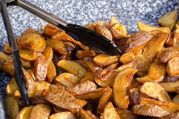 Potatoes cut into pieces with spices. Baked potatoes. Potatoes by the peasants.