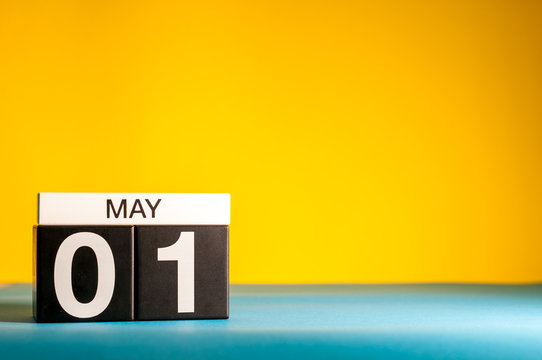 May 1st. Day 1 of may month, calendar on yellow background. Spring time, International labor day