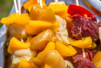 Raw chicken and beef skewers resting on a tray