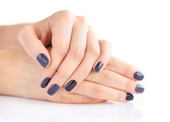 Closeup of hands of a young woman with dark manicure on nails