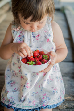ripe strawberry in the hands of a close-up child