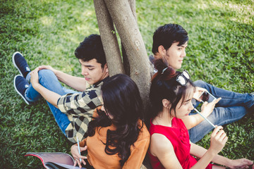 Fototapeta premium Asian young teen student sitting in park for studying and education concept