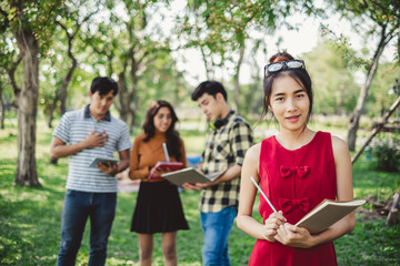 portrait asian young teen student standing in park for studying and education concept
