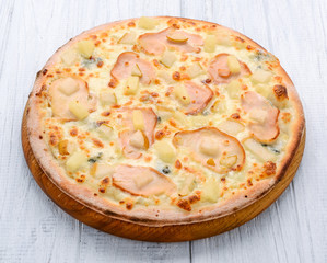 Pizza with ham, apples and pineapple
