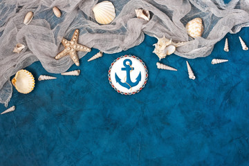 Sea shells and stones on blue background. Top view with cope space