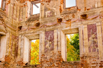 Fototapeta na wymiar Frescoes on the walls of an old abandoned manor house of the 18th century, a view from the inside. Belkino Manor, Russia