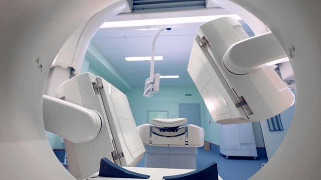 White tomograph works in a clinic.
