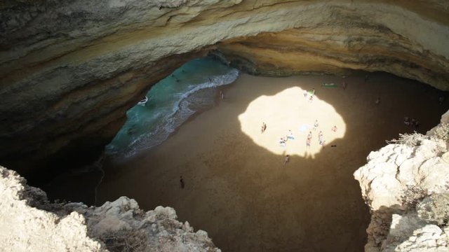 Benagil Cave seen from the top of rocky cliff in Algarve coast. Aerial view of famous sea caves with boat trips leading to visit the caves from Praia de Benagil in Portugal.