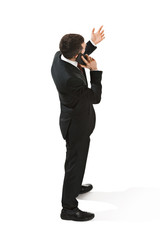 Obraz premium Back view portrait of a businessman. Confident professional with mobile phone