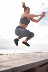 Pretty young woman jumping on stairs