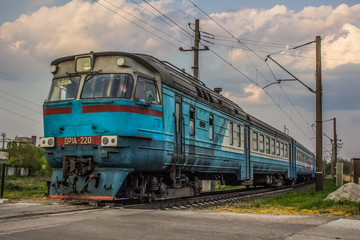 Obraz premium Railroad train in trip time on country side landscape in poor industrial environment 