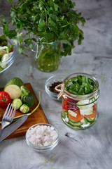 Fresh vegetable salad and ripe veggies on cutting board over white background, close up, selective focus