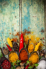 Various colorful spices on wooden table