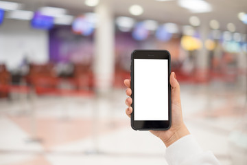 A woman hand holding smart phone device in the airport check-in background.
