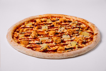 Pizza with chicken and pineapple isolated on white