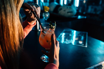 a girl drinks a cocktail