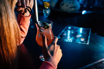 a girl drinks a cocktail