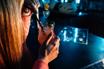 a girl drinks a cocktail