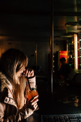 a girl drinks a cocktail