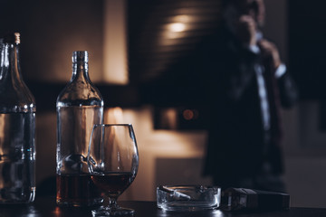 Bottle, glass and cigarettes