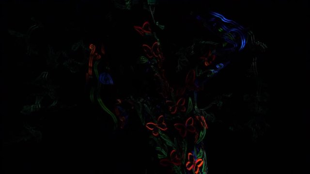 Montage video of a nude model with fluorescent butterflies on the body