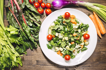 A mix of fresh vegetables on an old table ready to be cooked to taste