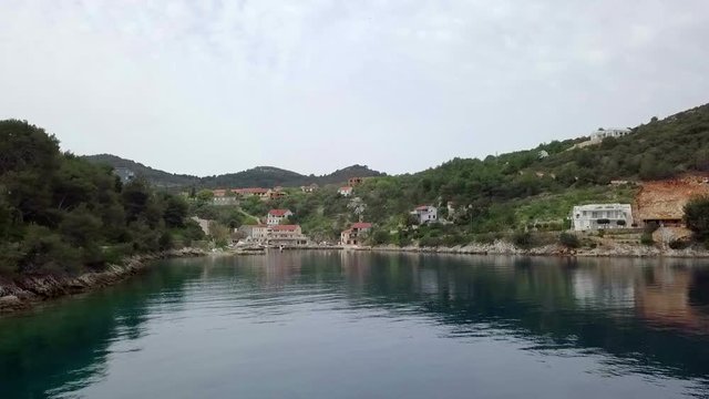 Aerial: Flying towards small beautiful blue green bay lagoon. Filmed while sailing in Croatia on islan Dugi otok behind village Sali at beautiful blue Adriatic sea.